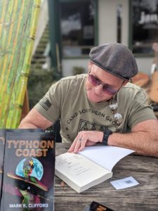 A USMC veteran signing a historical fiction book.