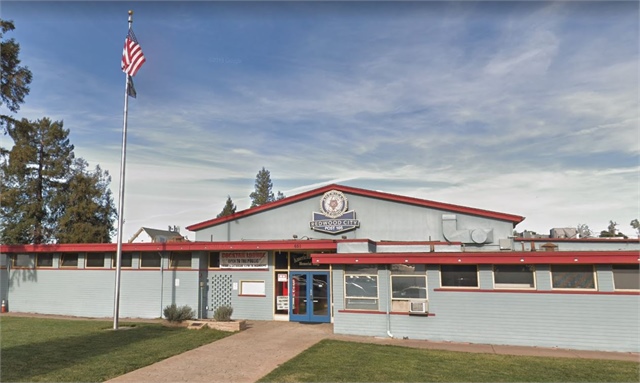 An image of a school building with an American flag, taken by Mark R. Clifford in Typhoon Coast.